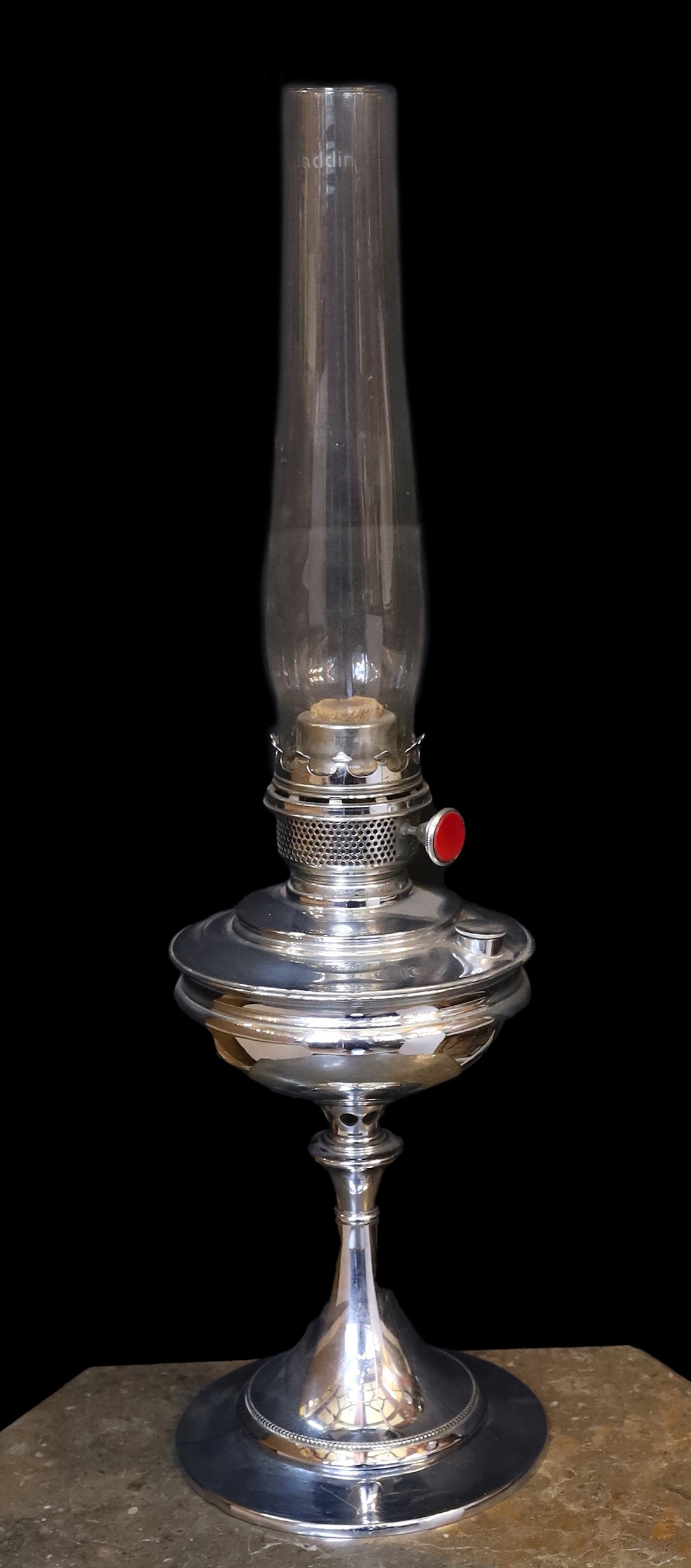 A 1930s nickel plated oil lamp with plain glass flue, height overall 68cm